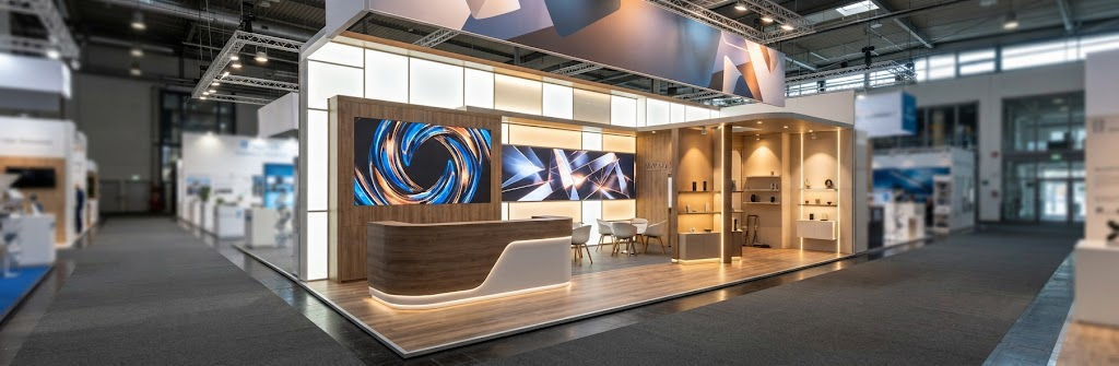 Modern exhibition stall design with lighting and display areas